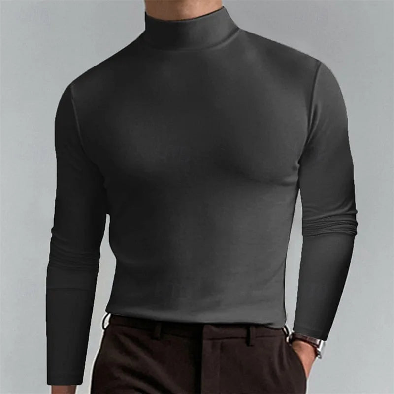 Man modelling a dark grey mock-neck top with slim long sleeves and a clean, fitted silhouette