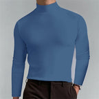 Man wearing a slate blue mock-neck jumper, showing the smooth fabric texture across the chest and arms