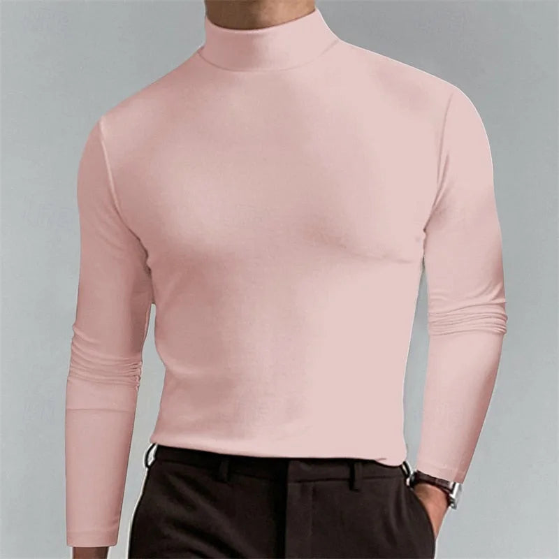Soft pink mock-neck top shown from the side, highlighting the sleek fit through the shoulders and torso