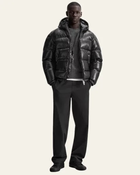 Detail shot of the side zip pocket on the glossy black puffer jacket