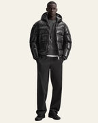 Detail shot of the side zip pocket on the glossy black puffer jacket
