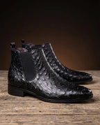 Glossy black Chelsea boots with ostrich-embossed leather pattern, elastic gusset panels and stacked block heel