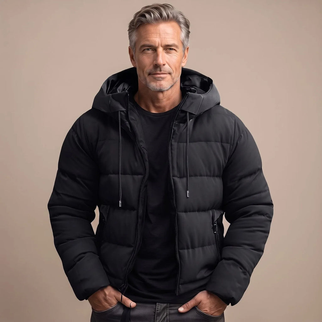 Man modelling a black quilted hooded puffer jacket, unzipped, showing ribbed side panels and drawstring toggles