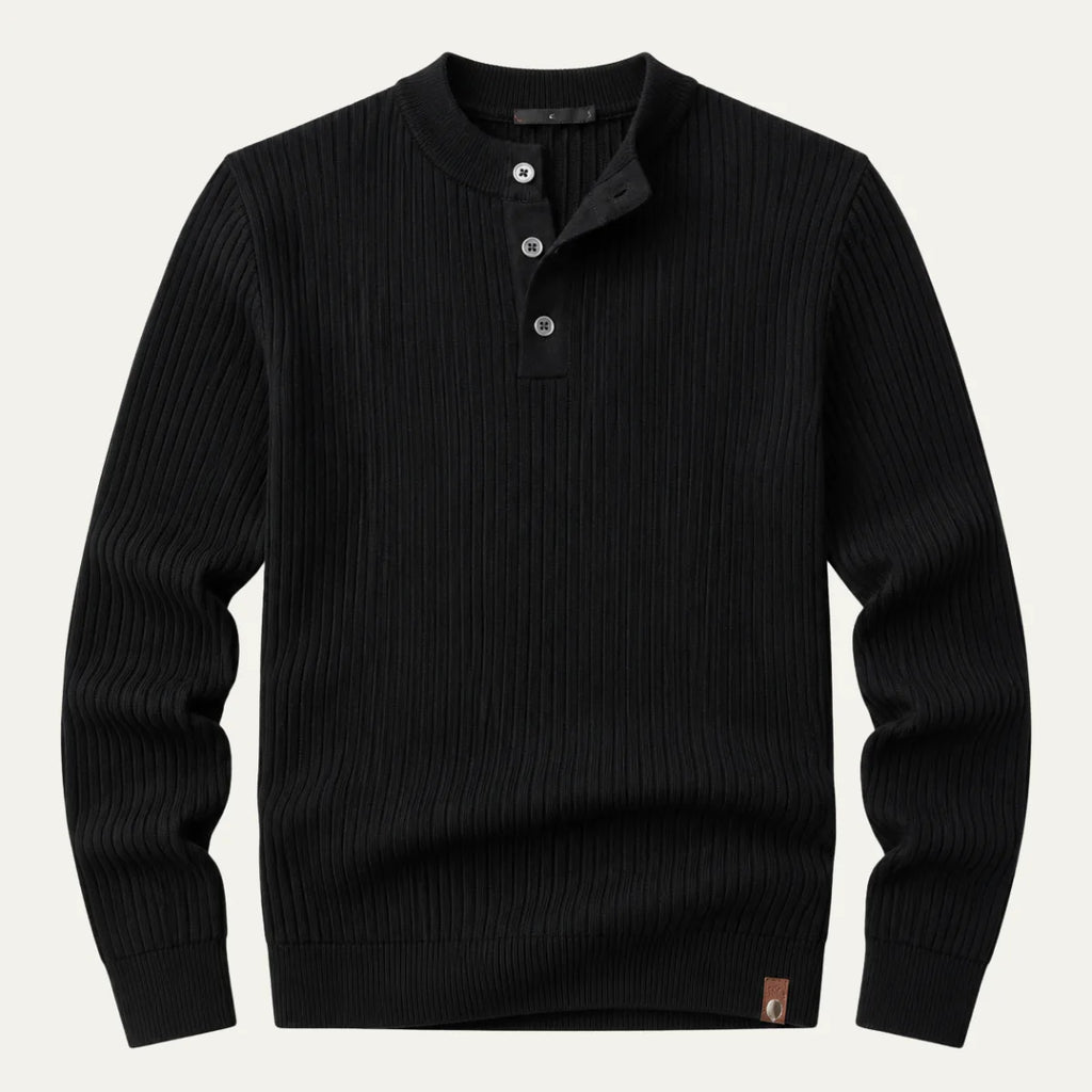 Flat lay of a black ribbed knit henley jumper with three-button placket and leather brand tab on the hem