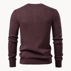 Side angle of a man wearing a black ribbed henley jumper, showing the fit through the shoulders