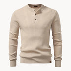 Close-up of the ribbed knit texture and buttoned stand collar on a black henley jumper
