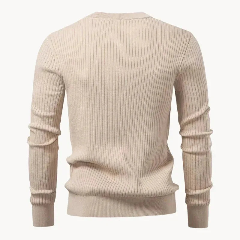 Man wearing a blue ribbed henley jumper, three-quarter view showing sleeve and cuff detail