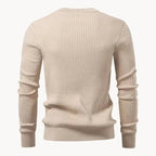 Man wearing a blue ribbed henley jumper, three-quarter view showing sleeve and cuff detail