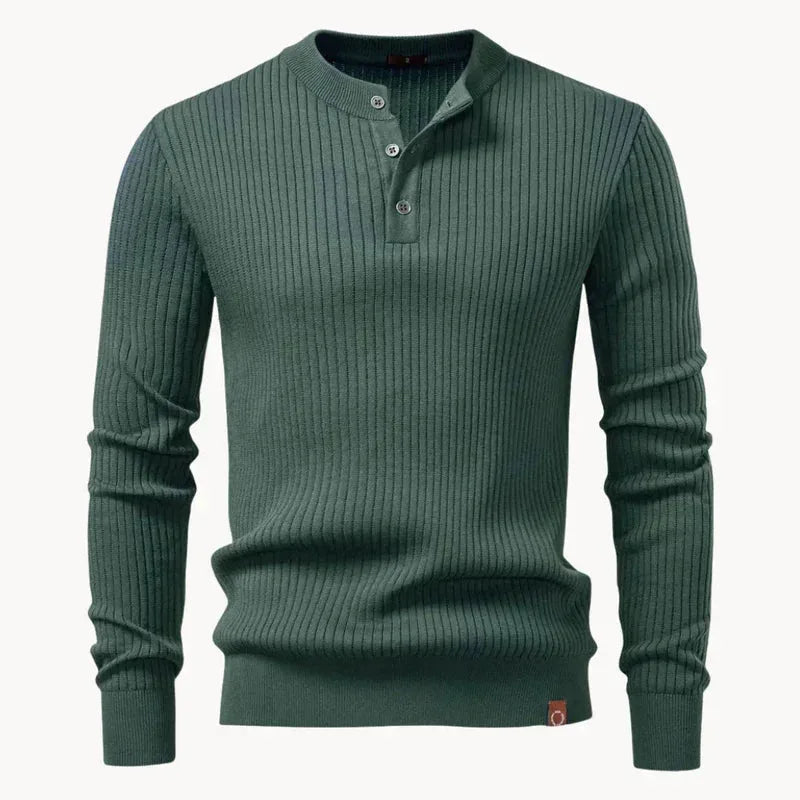 Close-up of the button fastening and collar on a slate blue ribbed knit henley jumper