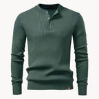 Close-up of the button fastening and collar on a slate blue ribbed knit henley jumper