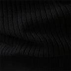 Flat lay detail of the ribbed knit cuff on a black henley jumper