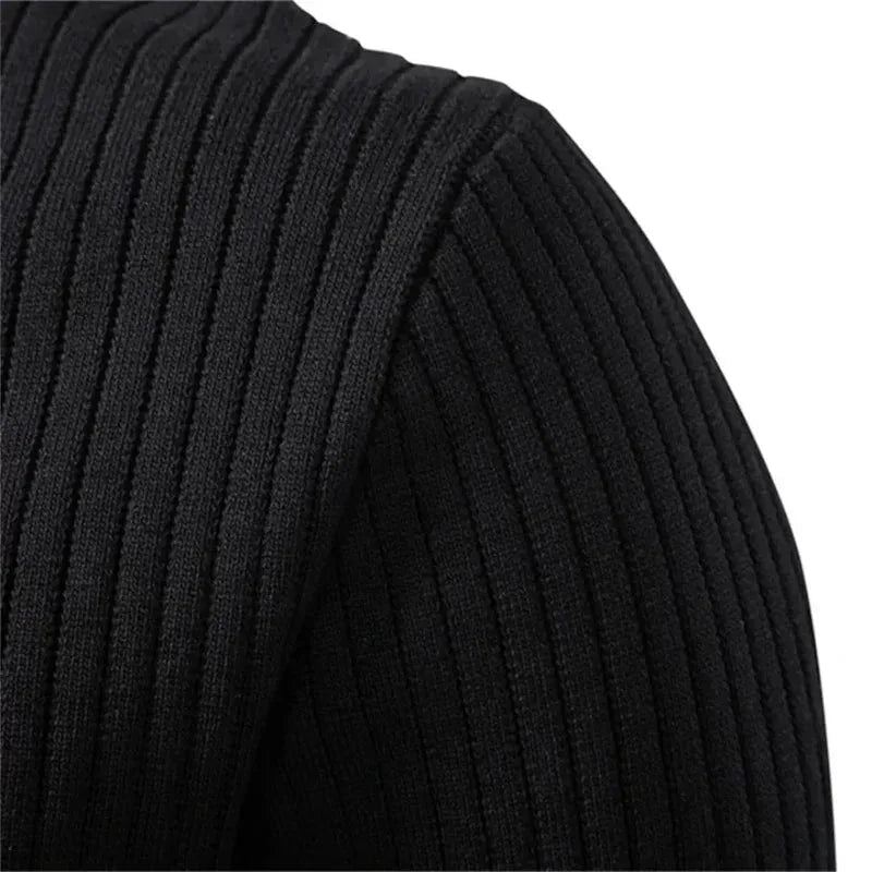 Close-up of the three-button henley placket with matte buttons on a black knit jumper