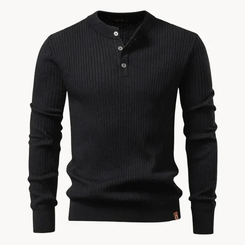 Front view of a black ribbed knit henley jumper on a mannequin form, showing the stand collar and buttons