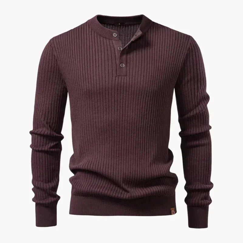 Flat view of a dark brown ribbed knit henley jumper with three-button collar and leather hem tab