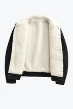 Black denim jacket laid flat and open, showing the full cream shearling lining and sleeves
