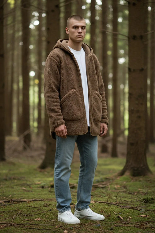 Full body shot of the brown sherpa fleece hoodie worn open over a white t-shirt with jeans and white trainers