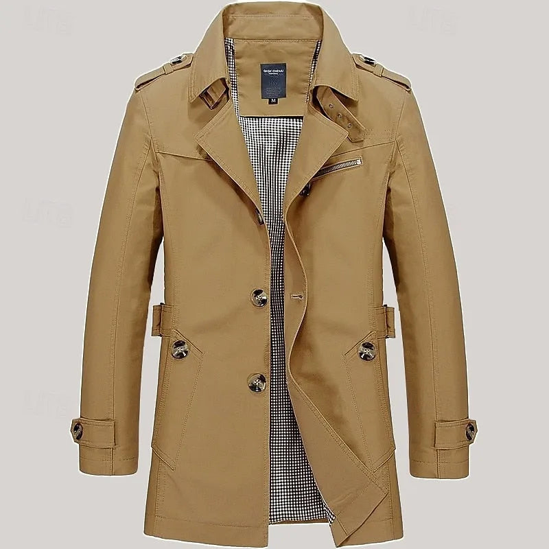 Navy blue trench coat close-up of collar, epaulette strap and buckled neck tab