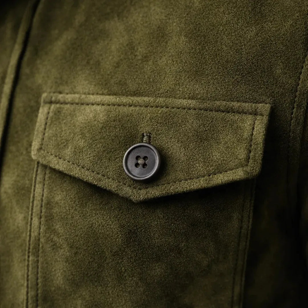 Close-up of the olive suede fabric texture and a stitched flap pocket with a four-hole button