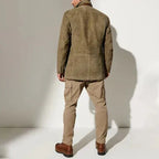 Rear view of khaki jacket worn with beige cargo trousers and brown leather boots, showing fitted back seam