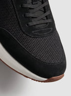 Close-up of the black suede toe cap and mesh upper showing contrast stitching and lace detail