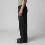 Three-quarter view emphasising the volume and clean fall of the wide trouser leg