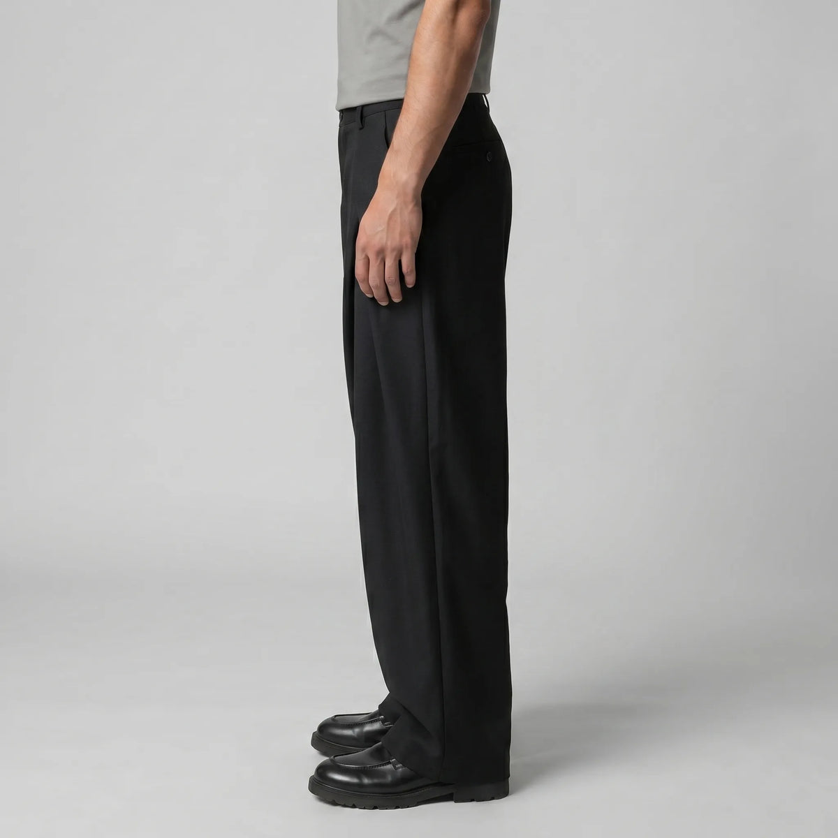 Three-quarter view emphasising the volume and clean fall of the wide trouser leg