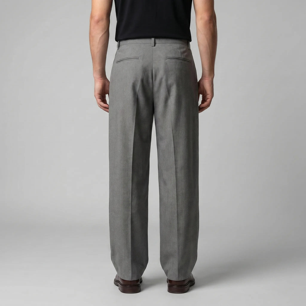 Back view of the grey tailored trousers showing the structured waistband and twin welt pockets