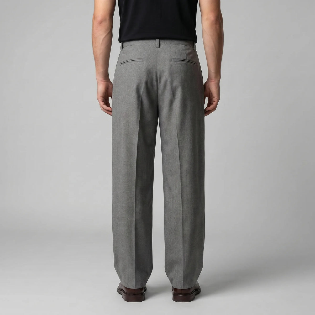 Back view of the grey tailored trousers showing the structured waistband and twin welt pockets