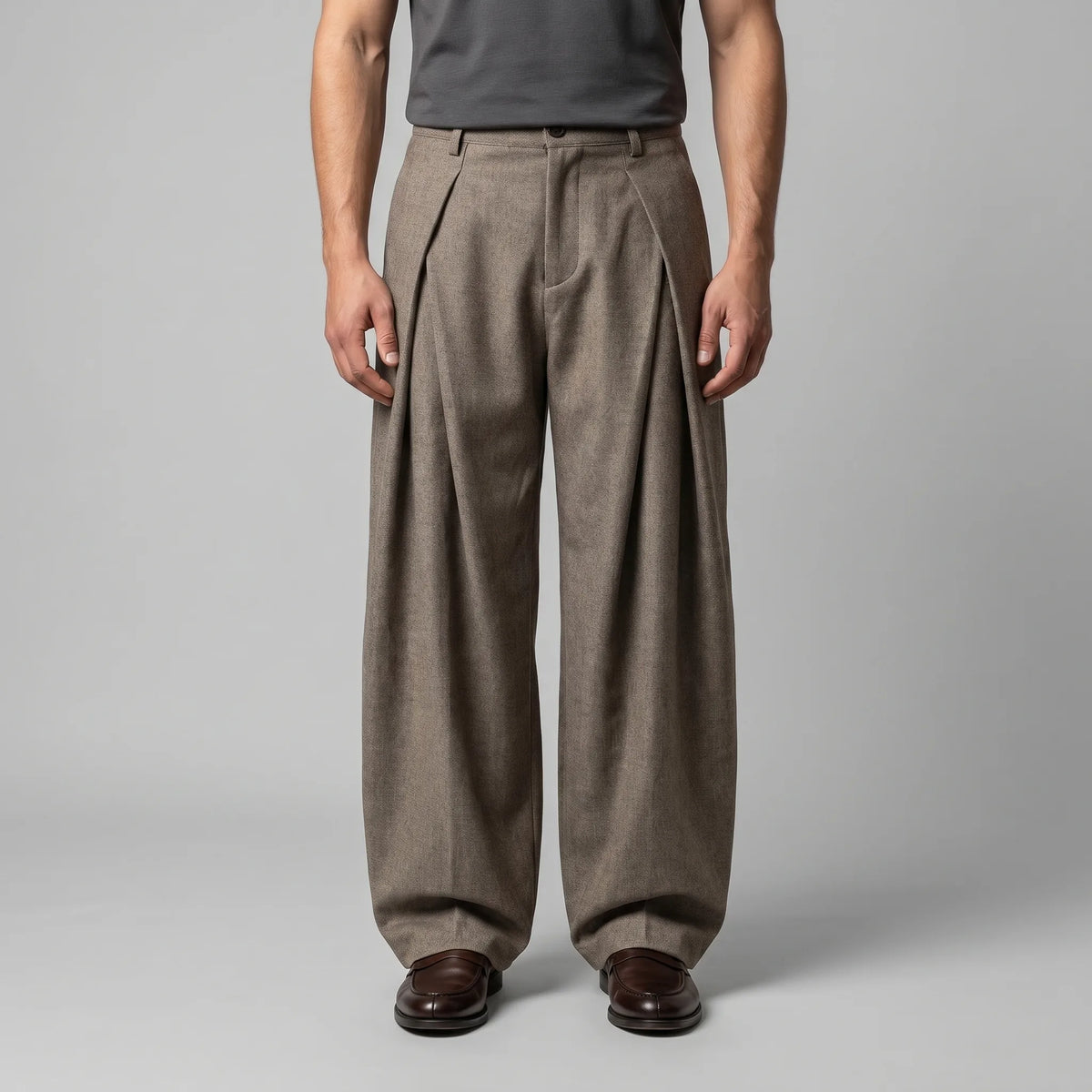Front view of beige wide-leg tailored trousers with deep front pleats, styled with a grey tank top