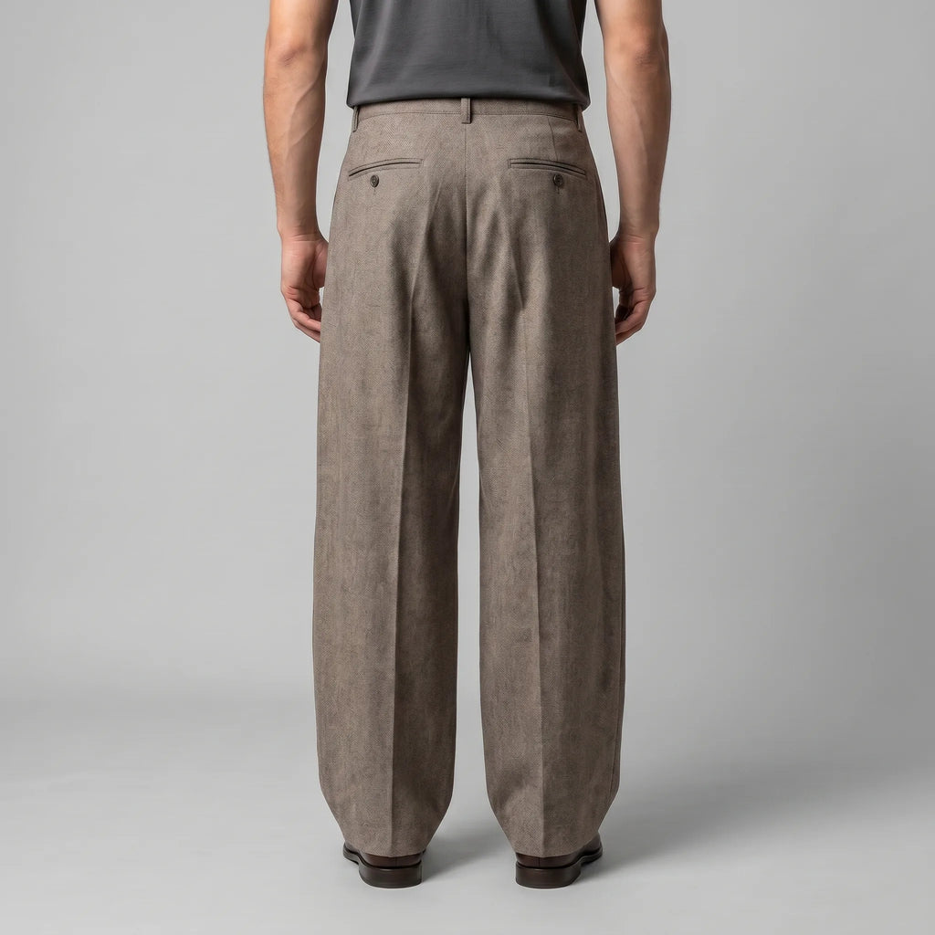 Back view of the beige tailored trousers highlighting the fitted waistband and double welt pockets