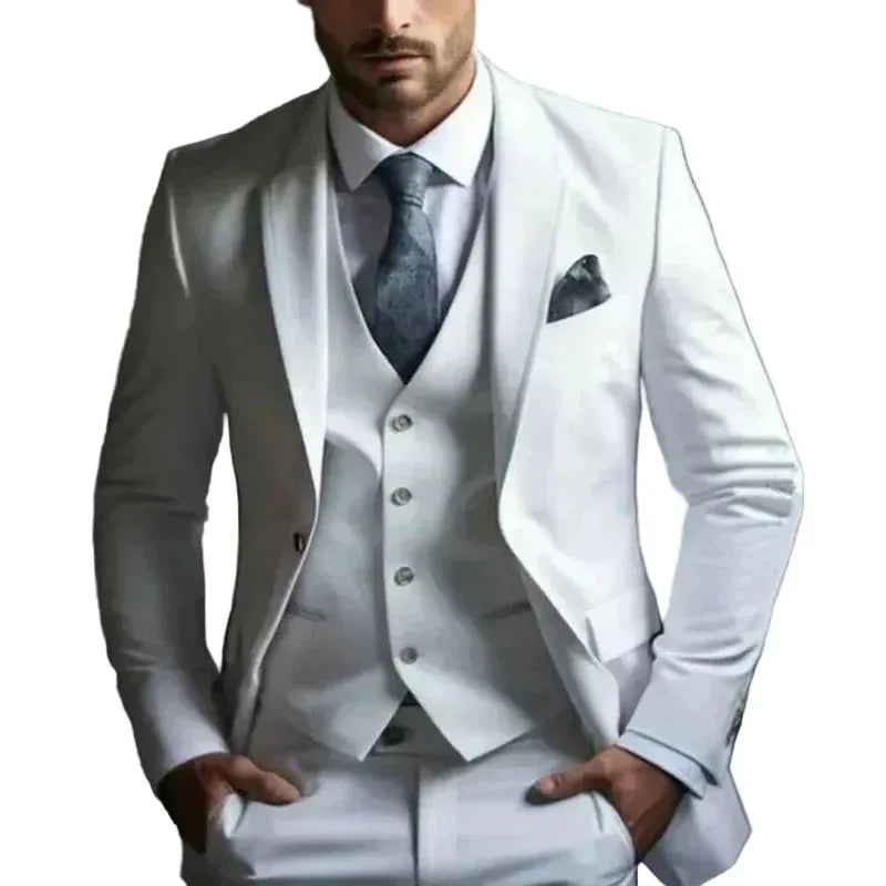 Model wearing a white three-piece suit with peak lapel blazer, buttoned waistcoat and grey patterned tie