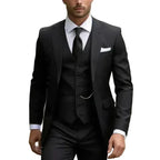 Black three-piece suit with peak lapels, six-button waistcoat and classic black tie