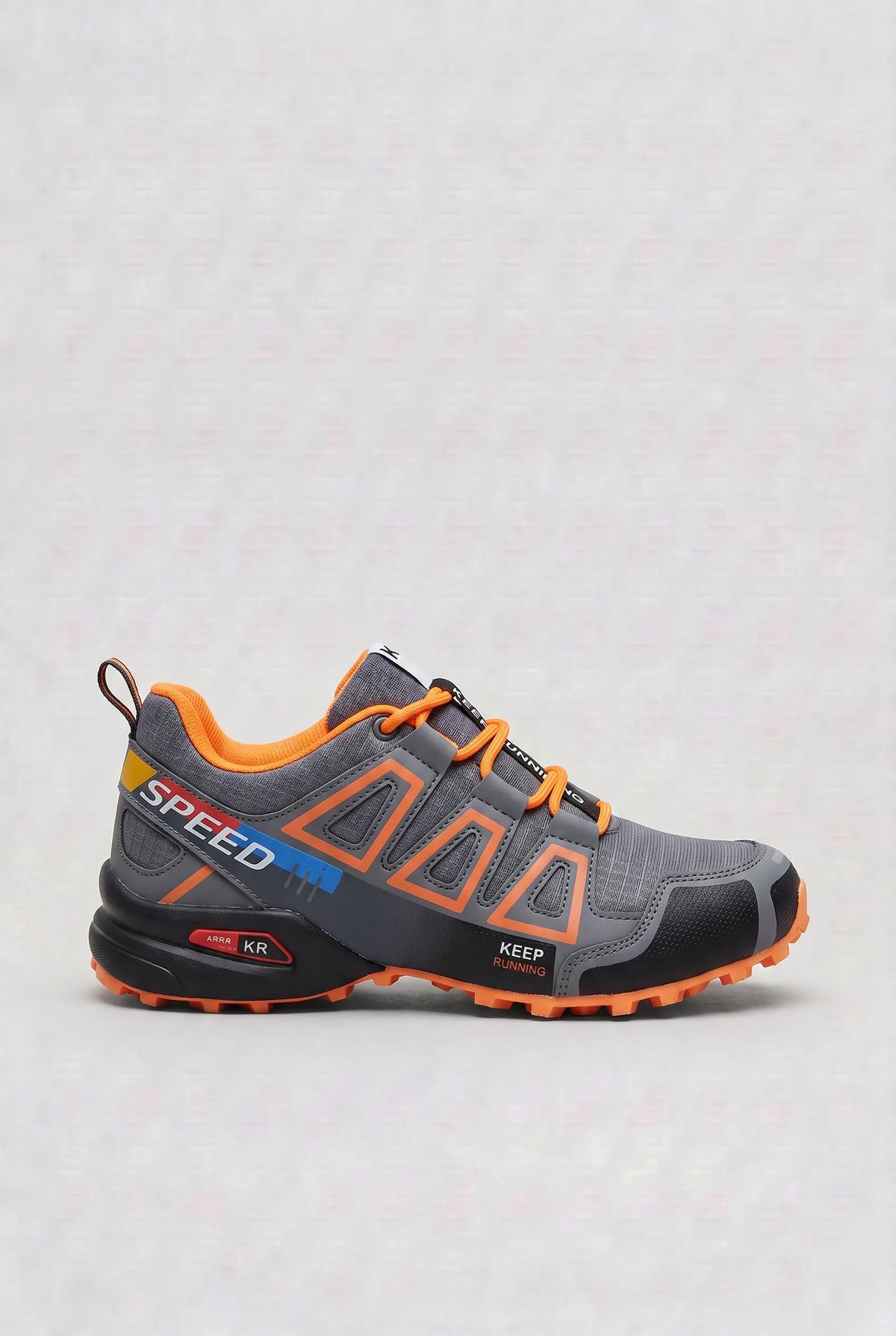 Side view of grey trainer with bold orange outlined panels, orange laces and orange accented sole