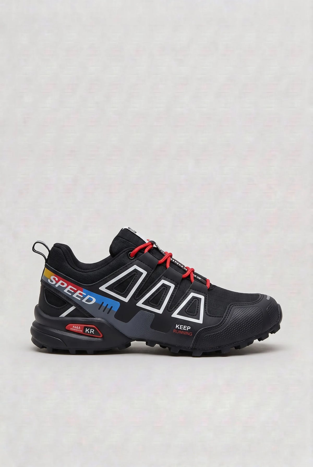 Side profile of black trainer with red, yellow and blue striped Speed branding and red laces
