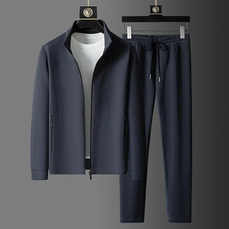 Grey twill-textured tracksuit jacket and matching joggers with drawstring waist displayed on hangers