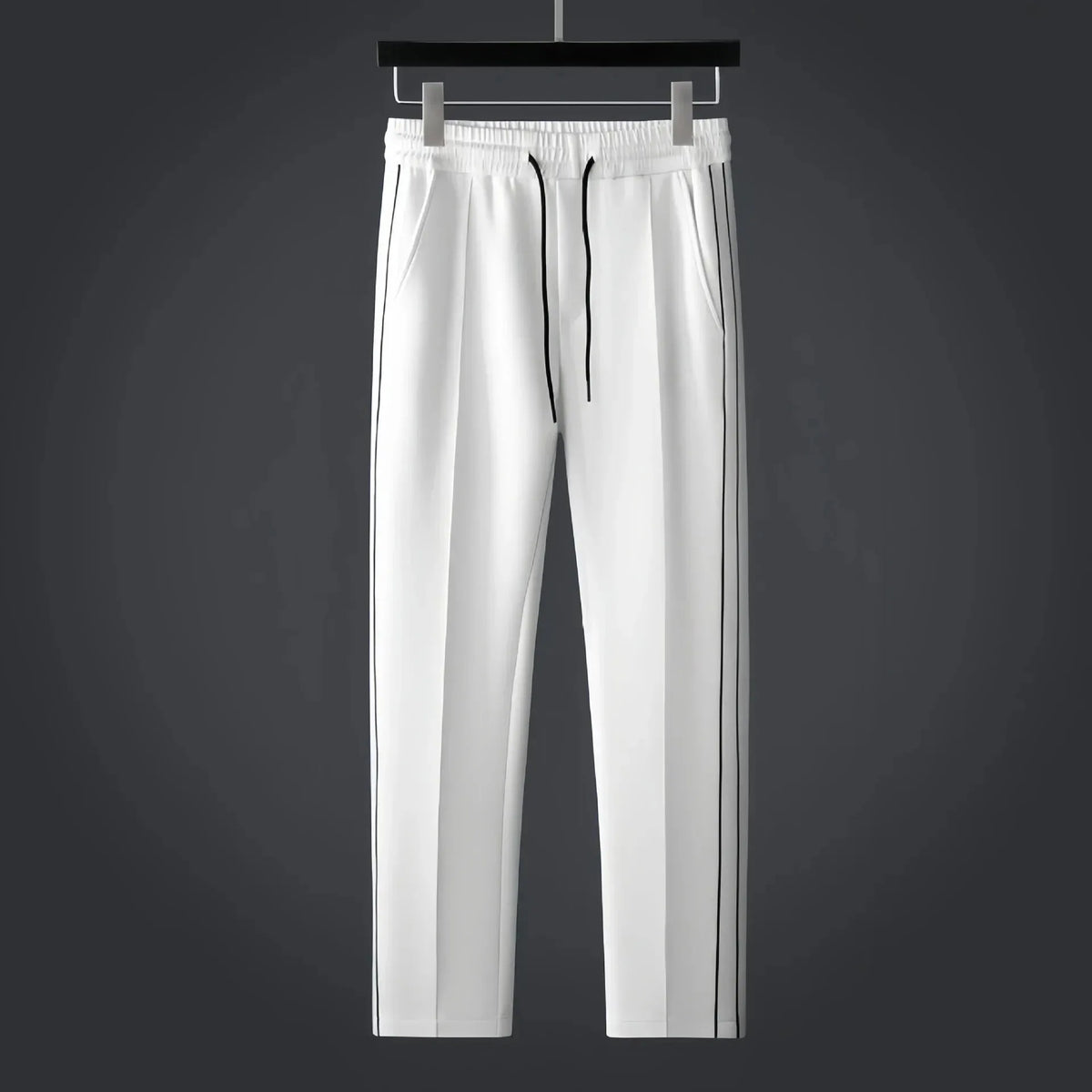 White tapered track trousers with drawstring waist, side pockets and thin black side stripes
