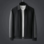 Front view of a black collared zip-up track jacket layered over a white t-shirt with white side stripes