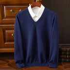 Navy V-neck jumper with visible white shirt collar, front view showing ribbed hem and cuffs