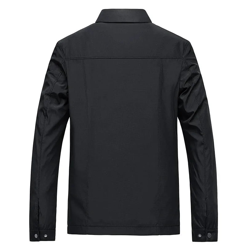 Back view of black jacket showing seam detailing across shoulders and button cuffs