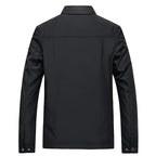Back view of black jacket showing seam detailing across shoulders and button cuffs