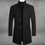 Black tailored wool overcoat with mandarin collar and button-through front, worn open over a black polo neck