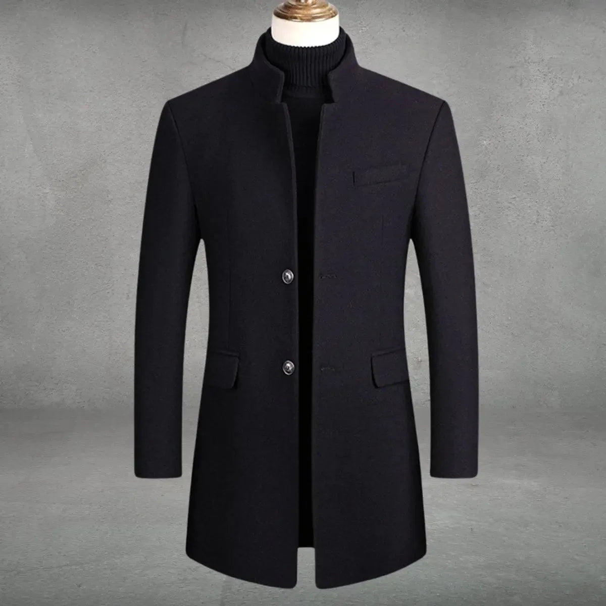 Navy-black wool overcoat variant showing structured shoulders, chest welt pocket and flap side pockets in close-up front view