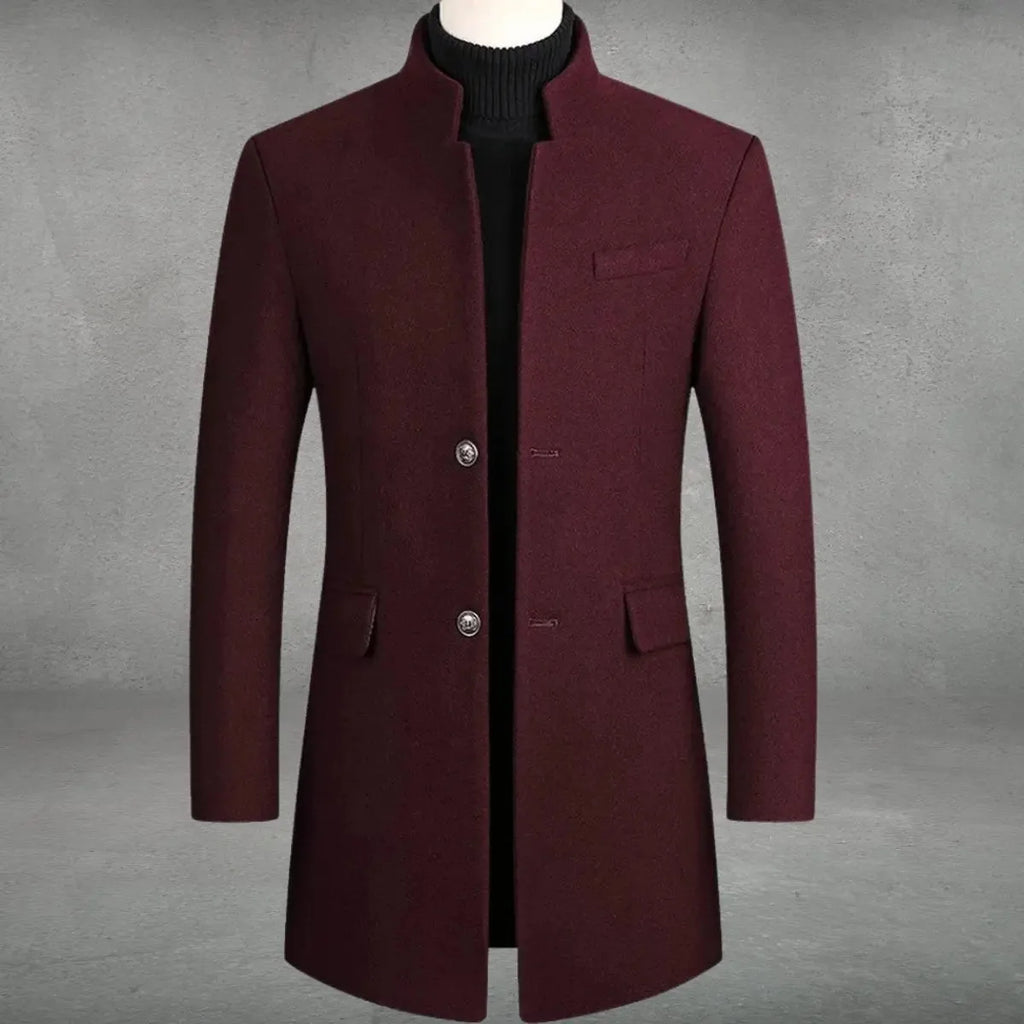 Burgundy wool overcoat with stand collar and two-button front fastening, displayed over a black polo neck on a tailor's form