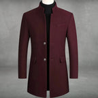 Burgundy wool overcoat with stand collar and two-button front fastening, displayed over a black polo neck on a tailor's form