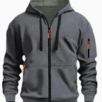 Front view of grey zip-up hoodie with contrasting green hood lining and orange zip pulls