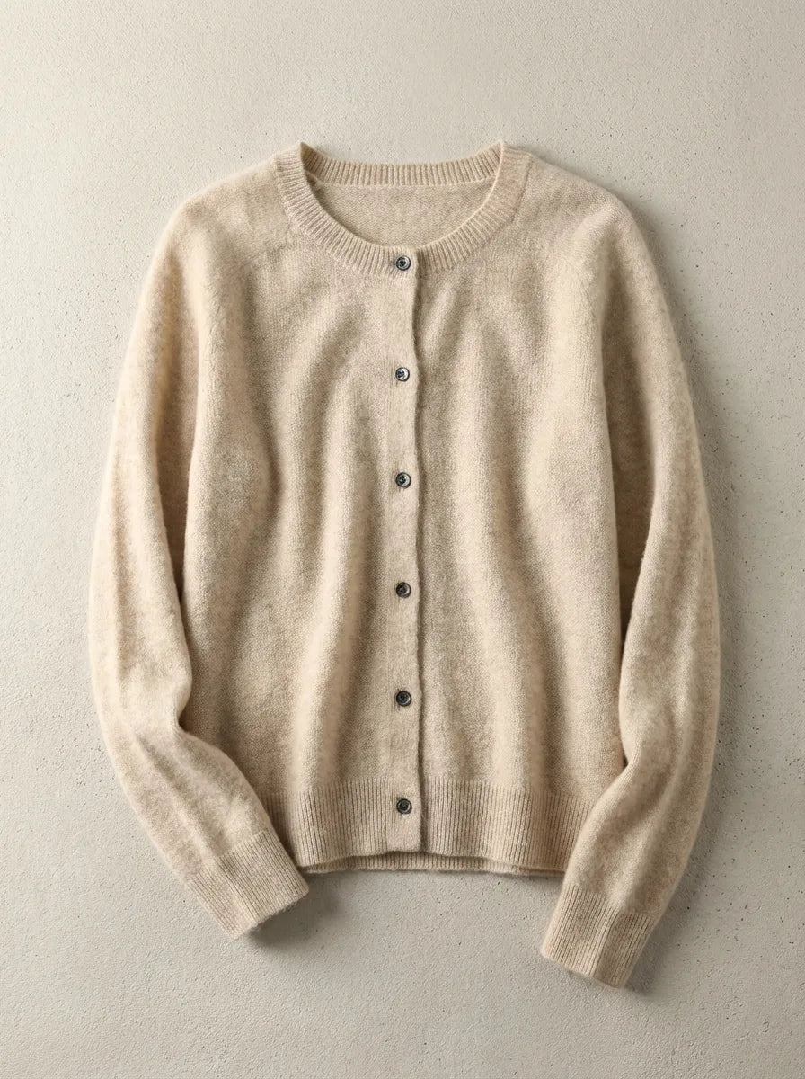 Beige cardigan in soft wool blend with crew neckline, shown flat against a light concrete background