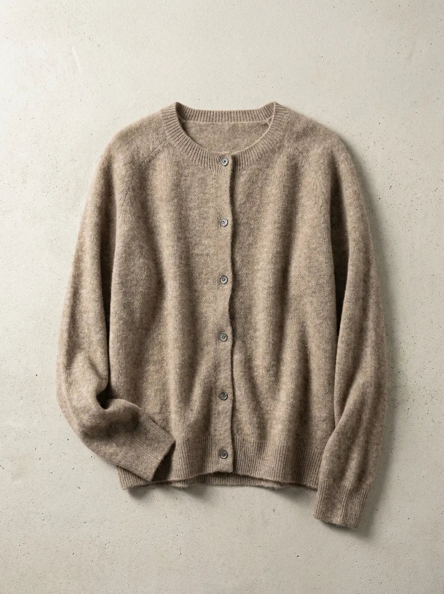 Close view of a knitted cardigan showing ribbed cuff detail and buttoned front placket