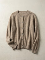 Close view of a knitted cardigan showing ribbed cuff detail and buttoned front placket