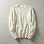 Folded sky blue merino wool jumper viewed from a slight angle highlighting the relaxed sleeve drape