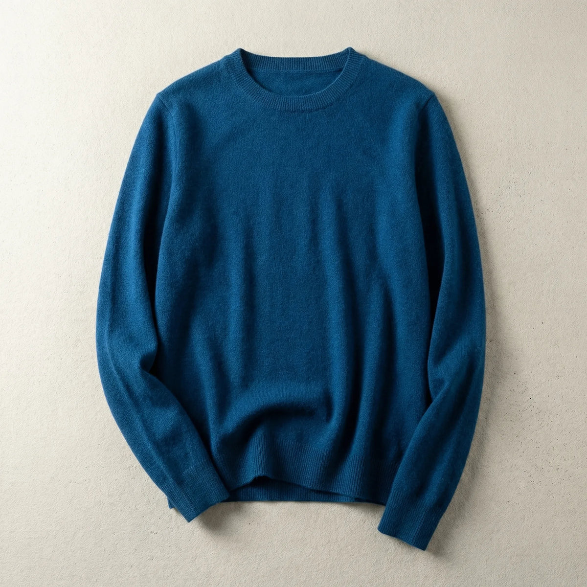 Close-up of camel brown merino wool jumper showing the soft brushed knit texture and ribbed collar